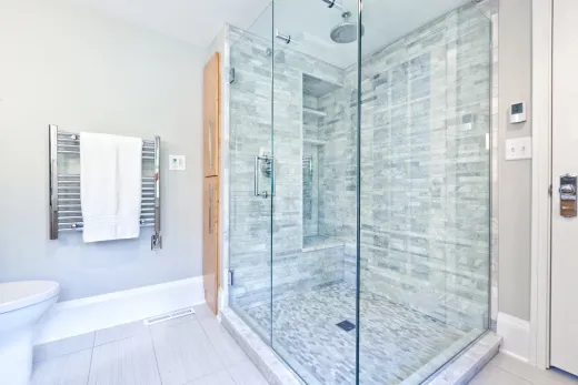 Garden suite bathroom with a marble walk-in shower in an Etobicoke suite
