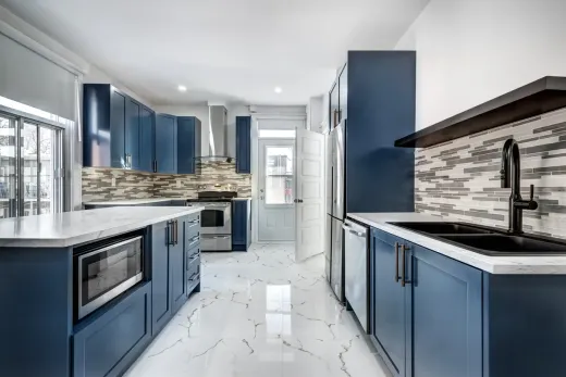 Garden suite kitchen with blue cabinetry and marble countertops